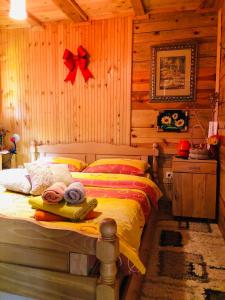 a bedroom with a bed in a log cabin at Etno Domaćinstvo Stanković in Gornji Milanovac +26 photos