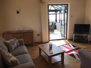 a living room with a couch and a coffee table at The Old Stable. Coombelands in Brighton & Hove