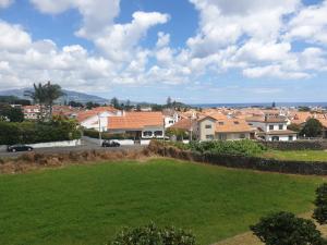 a view of a town with houses and a green field at Gorgeous House in Ponta Delgada