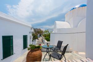 Un patio con sillas y una mesa en el balcón. en Avra Guestroom, en Apollonia