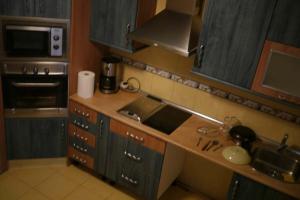 a kitchen with a sink and a counter top at Hostal El Alba in Brunete