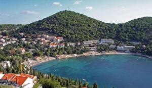 a view of a lake with a town and a mountain at Comfortable 3* Apartment Lapad Center in Dubrovnik