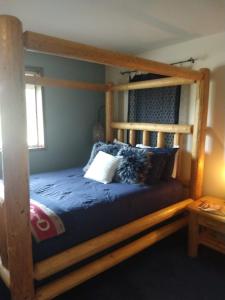 a bedroom with a wooden bunk bed with blue sheets at Wildwood Farm Bed & Breakfast in Oak Harbor