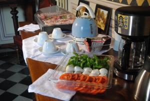 a table topped with a tray of eggs and vegetables at B&B Castello Machiavelli in Ozzano dell'Emilia