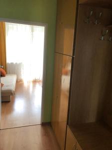 a living room with a dresser and a large closet at Pułaskiego 13/17 m.6 Apartament in Gdańsk