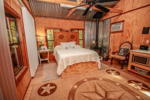 a bedroom with a bed in a room with wooden walls at The Tree House in Tyler