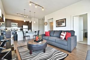 een woonkamer en een keuken met een bank en een tafel bij GA Living Suites - Knox District Uptown Dallas in Dallas