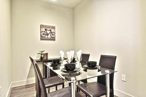 a dining room with a table with chairs and a bike on the wall at GA Living Suites - Knox District Uptown Dallas in Dallas