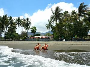 three people in the water on a beach at Lauhata Beach Escape in Liquica