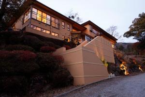 a house with a staircase leading up to it at Hakone Fura in Hakone