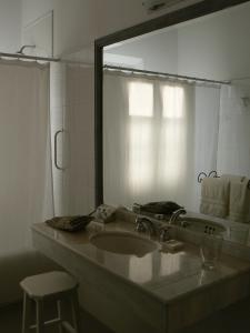 a bathroom with a sink and a mirror at La Merced Del Alto in Cachí