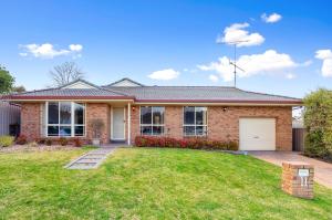 a brick house with a lawn in front of it at Maggie's Place in Mount Gambier