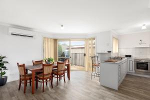 a kitchen and dining room with a table and chairs at Maggie's Place in Mount Gambier