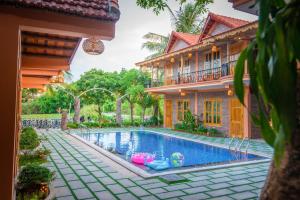 a house with a swimming pool in front of a house at Tam Coc Summer Bungalow in Ninh Binh
