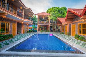 a swimming pool in the courtyard of a house at Tam Coc Summer Bungalow in Ninh Binh