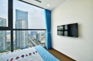 a bedroom with a bed and a large window at LUXURY APARTMENT VINHOMES SKYLAKE 5min to KEANGNAM in Hanoi