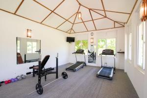 a gym with treadmills and exercise equipment in a room at Sungreen Resort in Habarana