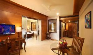 a living room with a table and a dining room at Uday Backwater Resort in Alleppey