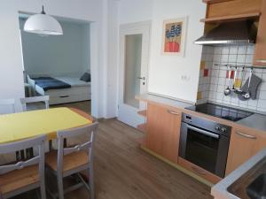 a kitchen with a table and a stove top oven at Apartma Vojvoda in Bohinj