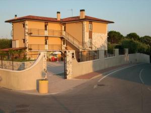 a large building with a ramp next to a street at Villa Mayoti B&B in Manerba del Garda +8 photos