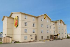 a large hotel with a sign on the side of it at Super 8 by Wyndham Yellowknife in Yellowknife