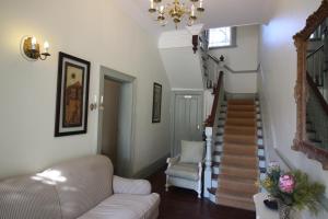 a living room with a staircase and a couch at Mountain Manor Guest House & Executive Suites in Cape Town