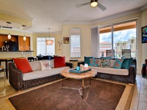 a living room with two couches and a table at Belle Harbor 701W Luxury Condo with Panoramic Water View. 23088 in Clearwater Beach