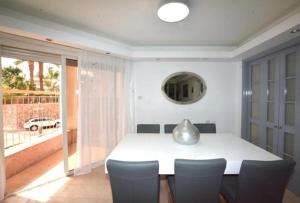 a white dining room table with chairs and a mirror at Sweethome26 EILAT Apt with Jaccuzzi / Free Parking in Eilat