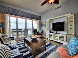 a living room with a couch and a tv at Harborview Grande 800 Luxury 8th Floor Condo with Stunning Harbor Views 23067 in Clearwater Beach