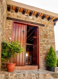 a stone building with a large wooden door at Farmakas Living in Farmakas