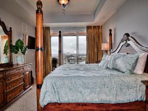 a bedroom with a bed and a large window at Harborview Grande 800 Luxury 8th Floor Condo with Stunning Harbor Views 23067 in Clearwater Beach +20 photos