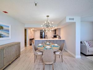 a dining room and kitchen with a table and chairs at Madeira Towers 802 Renovated Madeira Towers Beachfront 2 Bedroom 2 Bathroom Condo 23143 in St Pete Beach