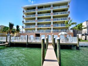 a hotel on the water next to a dock at Sandpiper's Cove 201 Sandpiper's Cove Luxury 3 Bedroom 2 Bathroom 23132 in Clearwater Beach