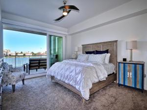 a bedroom with a bed and a large window at Sandpiper's Cove 201 Sandpiper's Cove Luxury 3 Bedroom 2 Bathroom 23132 in Clearwater Beach +24 photos
