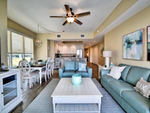 a living room with a couch and a table at Sandpiper's Cove 203 Luxury Waterfront 3 Bedroom 2 Bath Condo 23130 in Clearwater Beach