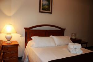 a bedroom with a bed with two towels on it at Hostal Los Maños in Albentosa