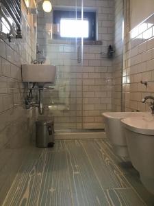 a bathroom with a sink and two toilets at Il Melograno House in Pollutri