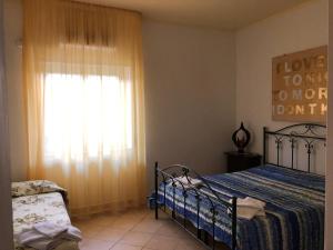 a bedroom with a bed and a window at Bed & Breakfast "Camera a Sud" in Cariati +26 photos