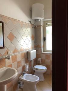 a bathroom with a toilet and a sink at Bed & Breakfast "Camera a Sud" in Cariati