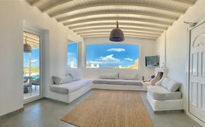 オルノスにあるStunning Villa 4BR in Mykonosのリビングルーム(ソファ、大きな窓付)