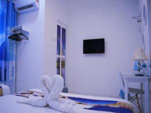 a hospital room with a bed in a room with a window at Santorini Hotel Melaka in Melaka