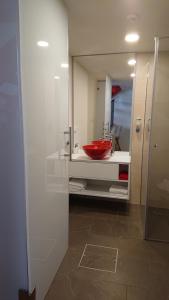 a bathroom with a red sink and a mirror at Maison am Liesingbach in Vienna