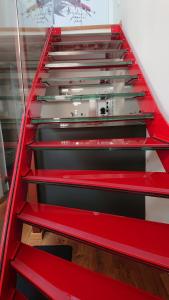 a set of stairs with red and black risers at Maison am Liesingbach in Vienna