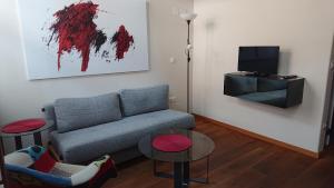 a living room with a couch and a tv at Maison am Liesingbach in Vienna