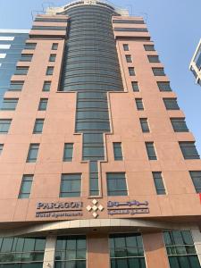 a tall building with a pentagon sign on it at Paragon Hotel Apartments in Abu Dhabi