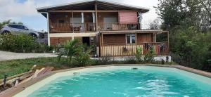 una casa con piscina di fronte a una casa di Gîte Bananier a Bouillante