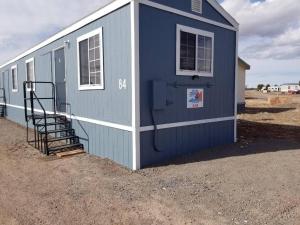 a blue building with a staircase in front of it at 084A Cozy Retreat with Kitchen nr South Rim Sleeps 4 in Valle