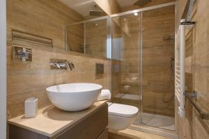 a bathroom with a sink and a glass shower at Vivaldi luxury suites in Florence +56 photos