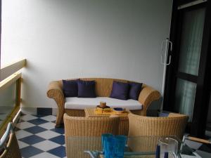 a living room with a couch with blue pillows at FLATS SOLARIUM in Bibione