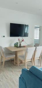 a living room with a wooden table and two chairs at Apartmani Bilić in Korenica
